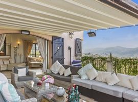 A cosy seated terrace that opens onto the main house looking across the valley to the bay of Cannes.