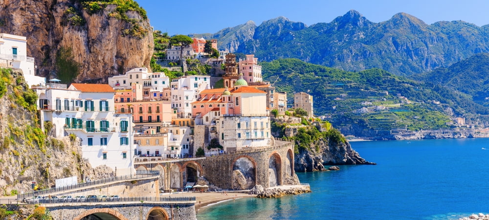 Italian village on lake with mountains in the background