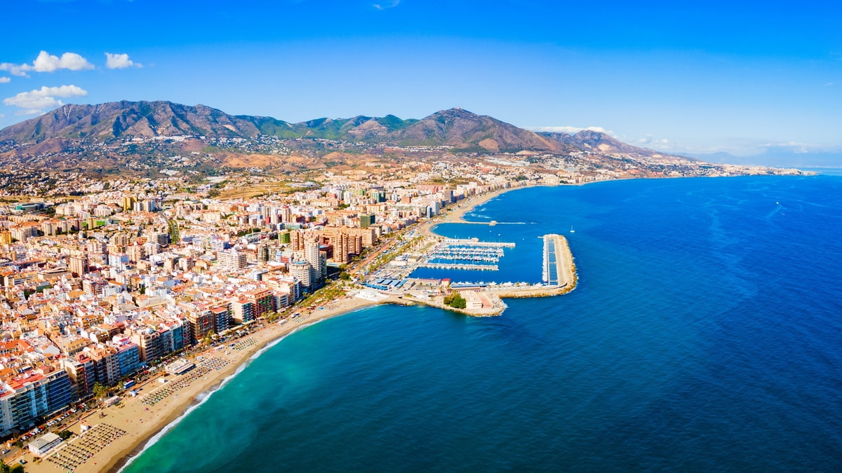 Aerial view of the Costa Del Sol showing the harbour and dramatic mountains. 