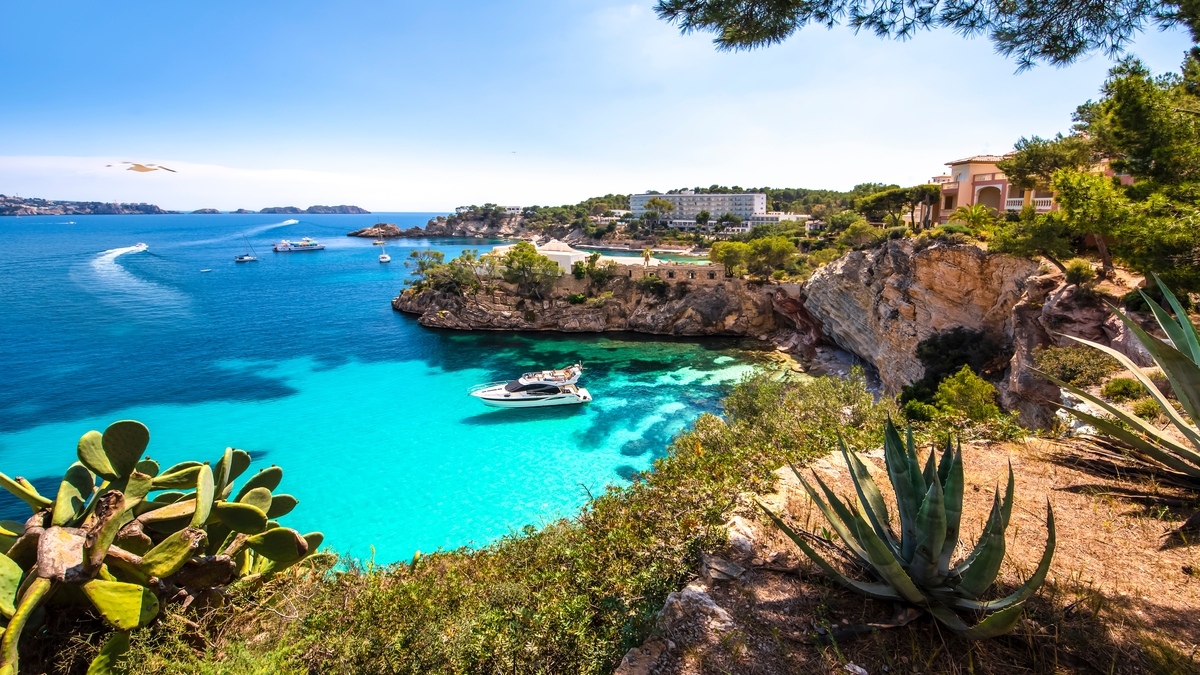 jaw dropping scene of a bay in mallorca with a boat